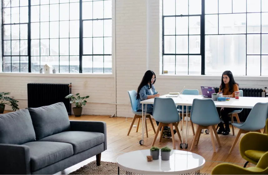 Two woman reading in a room
