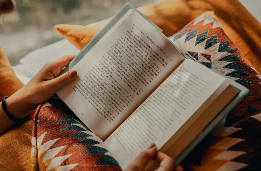 A person reading a book submission for review.